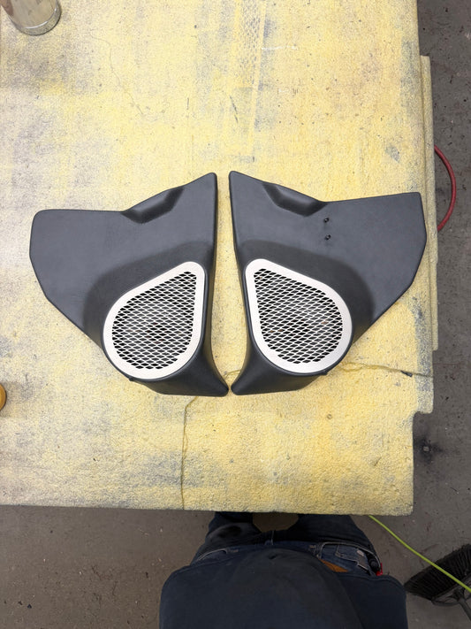 Custom square body kick panels with stainless steel speaker grilles