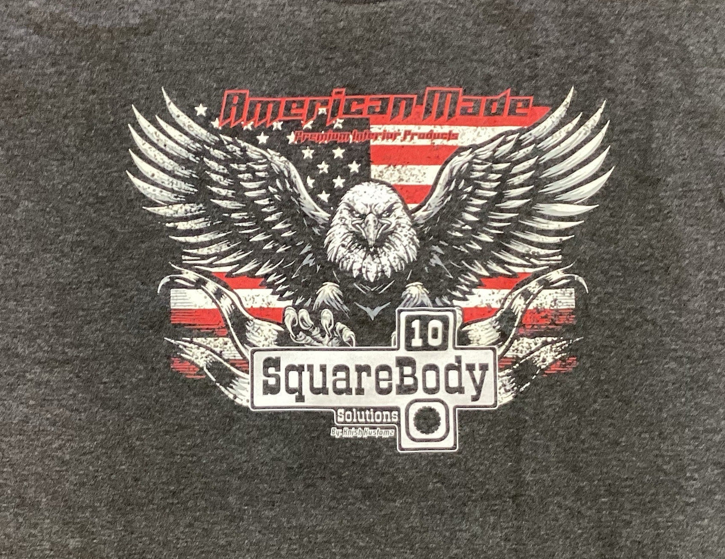 Gray t-shirt with an eagle graphic and Square Body Emblem on an american flag