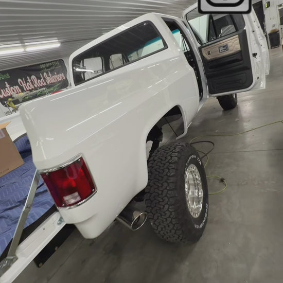 Rear storage compartment behind the rear seat in a square body truck