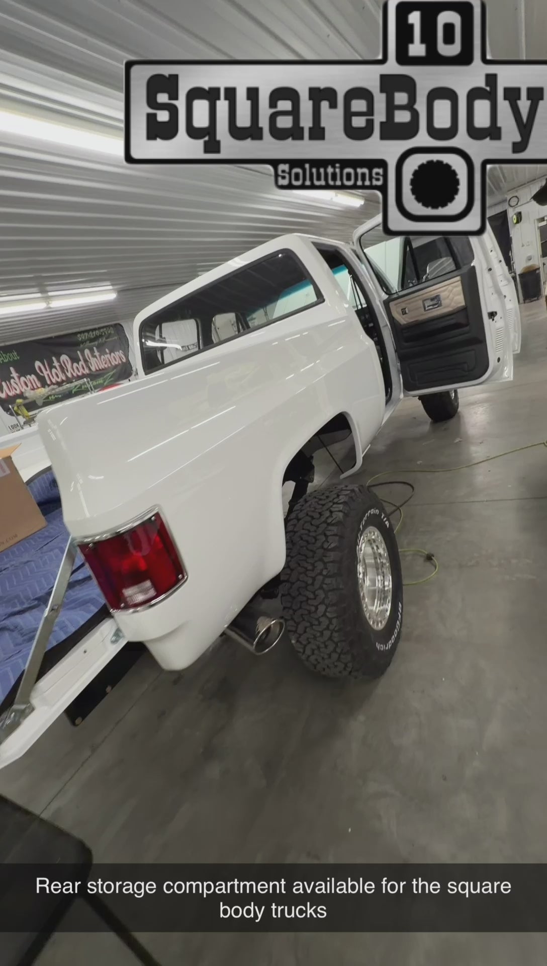 Rear storage compartment behind the rear seat in a square body truck
